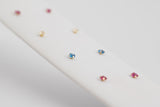 Èze is a pair of fine stud earrings made with 18k yellow gold and simulated sapphires.  Simple and elegant, these mini sapphire studs are one of our classic ear stack staples.