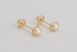 Gabrielle is a pair of fine pearl earrings made with 18k yellow gold and natural pearls.  Beyond elegant, this classic and delicate earring is adorned with natural pearls in a simple prong set design. They are sure to become your new favourite.