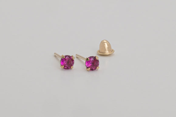 Èze is a pair of fine stud earrings made with 18k yellow gold and simulated rubies.  Simple and elegant, these mini ruby studs are one of our classic ear stack staples.