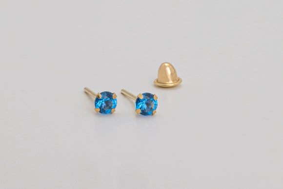 Èze is a pair of fine stud earrings made with 18k yellow gold and simulated sapphires.  Simple and elegant, these mini sapphire studs are one of our classic ear stack staples.