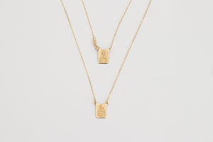 Escapulario is a solid 18k yellow gold necklace.  It was originally worn with a religious meaning but in our days, it's vintage style design is adopted by many. From the Latin Scapula, our Escapulario has the Virgin Mary on one side and on the other Jesus.