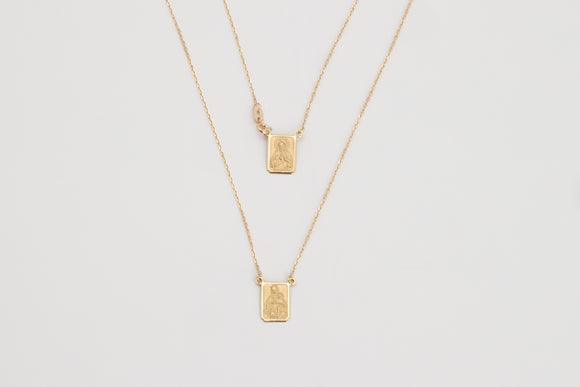 Escapulario is a solid 18k yellow gold necklace.  It was originally worn with a religious meaning but in our days, it's vintage style design is adopted by many. From the Latin Scapula, our Escapulario has the Virgin Mary on one side and on the other Jesus.